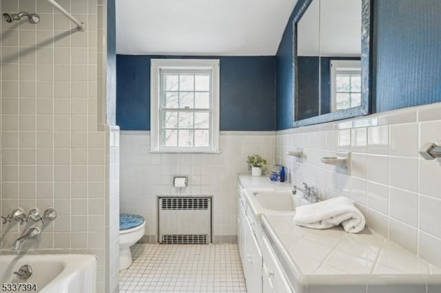 full bathroom featuring radiator, a wainscoted wall, toilet, tile patterned flooring, and vanity