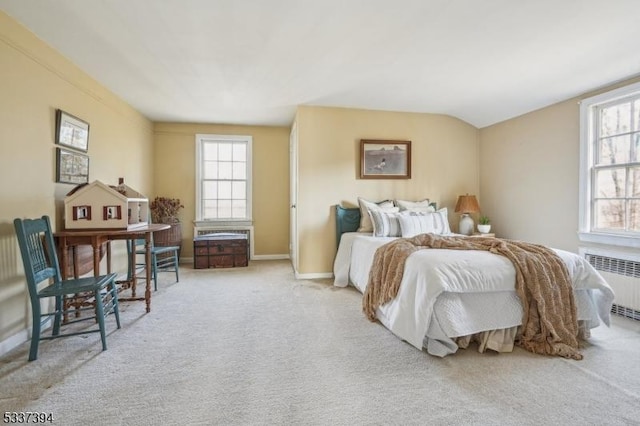 carpeted bedroom featuring radiator and baseboards