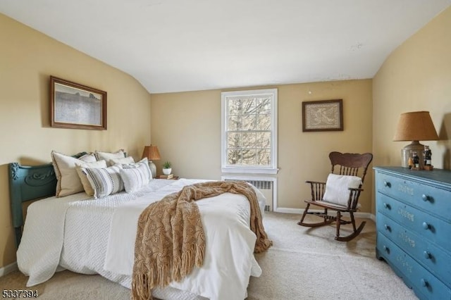 bedroom featuring radiator, light carpet, vaulted ceiling, and baseboards