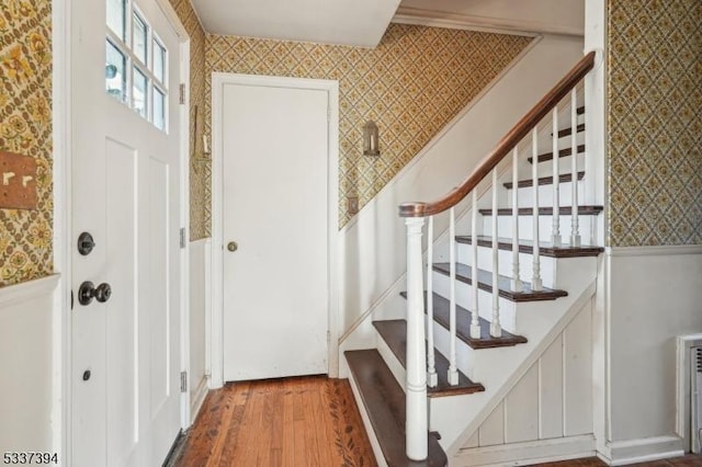 entryway featuring wood finished floors and wallpapered walls