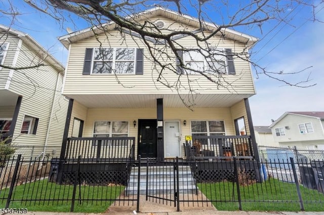 view of front of property featuring covered porch and a front yard