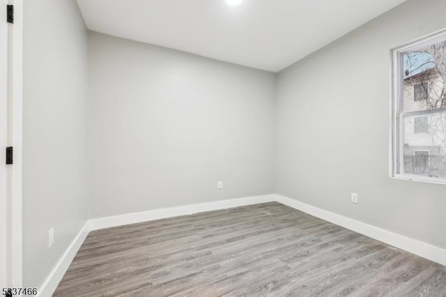 unfurnished room featuring hardwood / wood-style floors