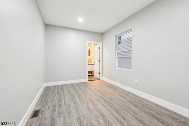 spare room featuring light hardwood / wood-style flooring