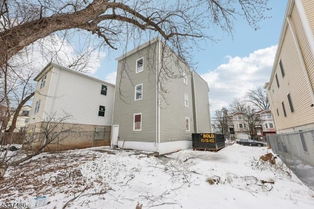 view of snow covered rear of property