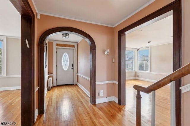 foyer featuring ornamental molding and light hardwood / wood-style floors