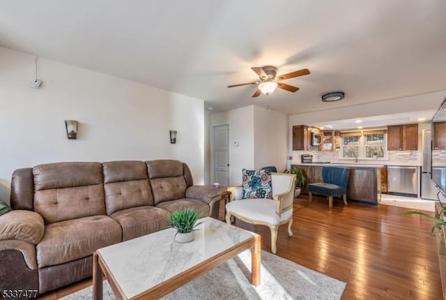 living room featuring hardwood / wood-style floors and ceiling fan