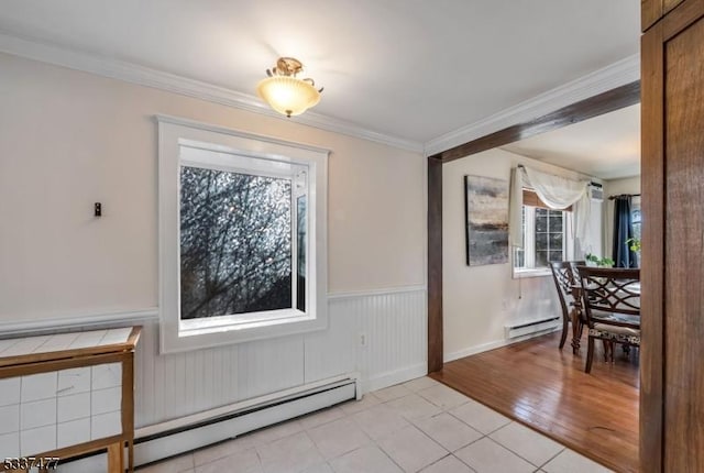 dining space featuring crown molding, light wood-type flooring, and baseboard heating