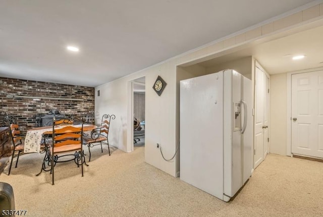 interior space featuring brick wall and light carpet