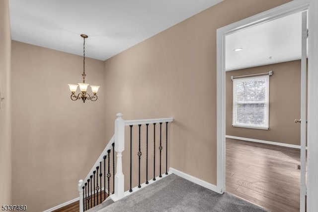 stairs with a chandelier and baseboards