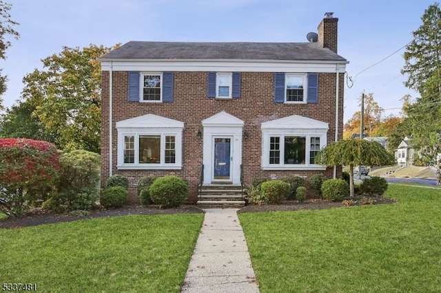 colonial-style house with a front lawn