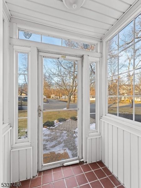 unfurnished sunroom with a healthy amount of sunlight