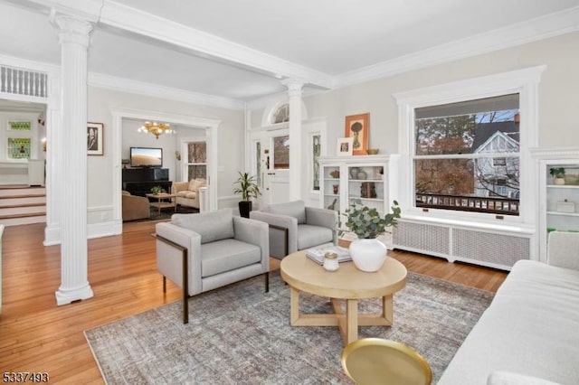 interior space with hardwood / wood-style floors, ornate columns, and radiator