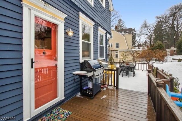 snow covered deck featuring a grill