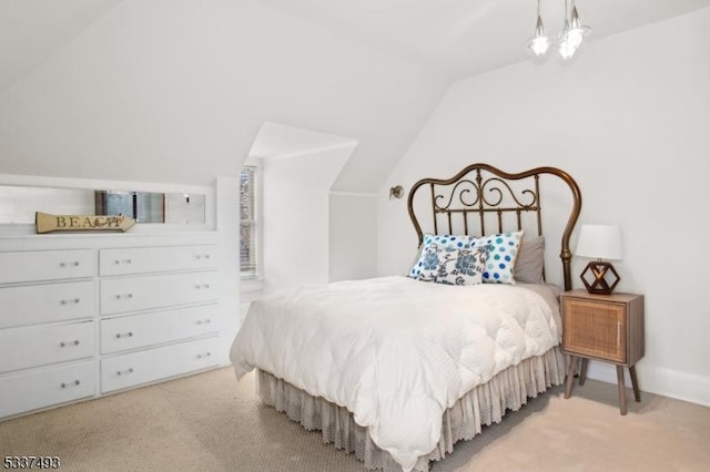 carpeted bedroom featuring vaulted ceiling and a notable chandelier