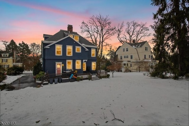 snow covered property featuring a porch