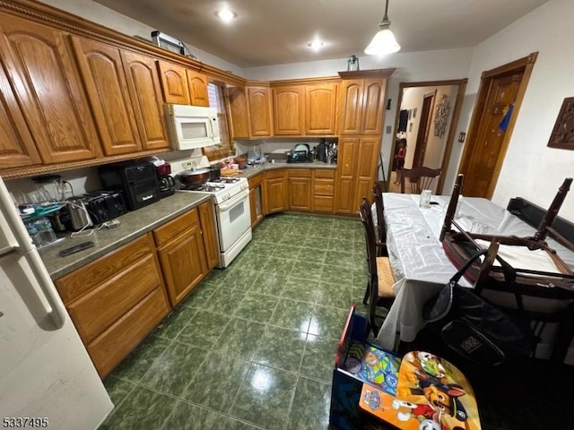 kitchen with white appliances and decorative light fixtures