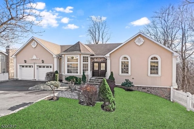 single story home with a garage and a front yard