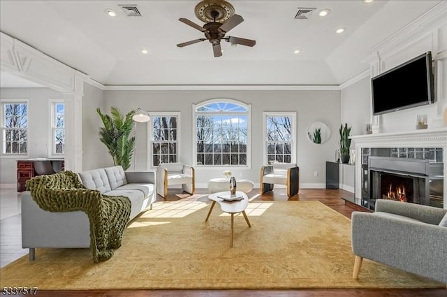 living room featuring ceiling fan, a wealth of natural light, and hardwood / wood-style floors