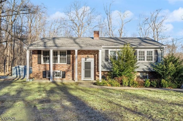 bi-level home with a front lawn and a patio