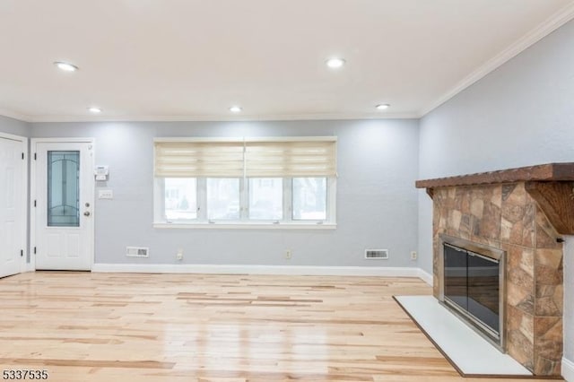 unfurnished living room with crown molding and light hardwood / wood-style flooring