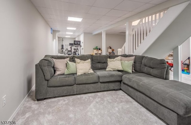 carpeted living room featuring a paneled ceiling