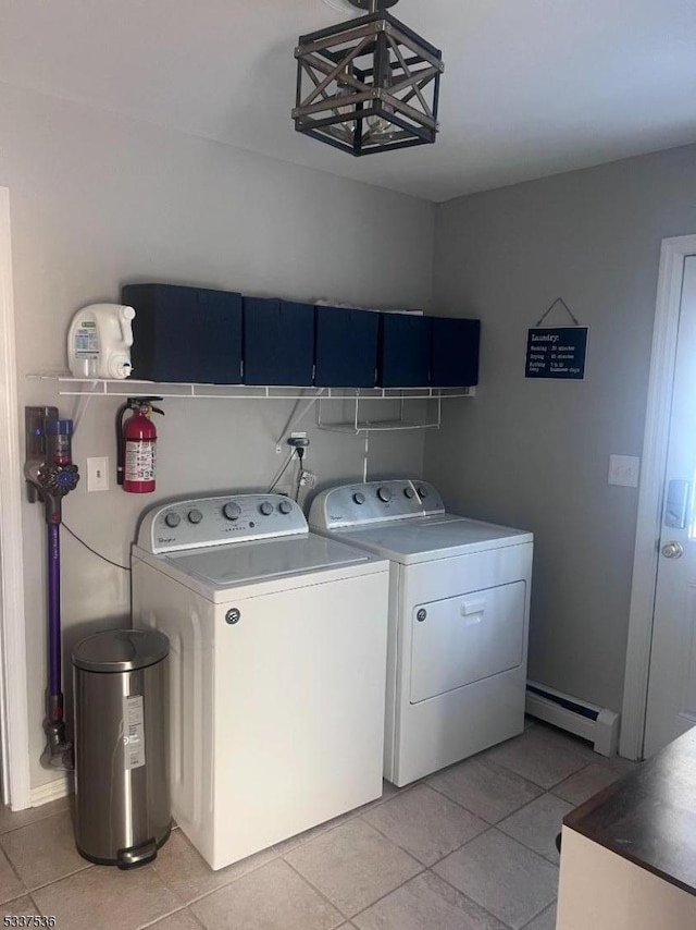 laundry room with light tile patterned floors, a baseboard radiator, and washing machine and clothes dryer