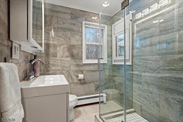 bathroom featuring vanity, a baseboard heating unit, toilet, a shower with door, and tile patterned floors