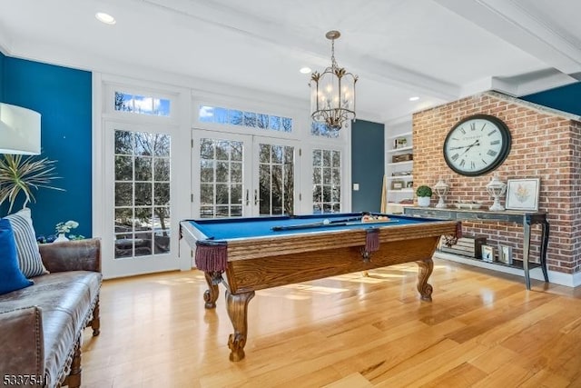 recreation room with light wood-style flooring, pool table, french doors, built in shelves, and beam ceiling