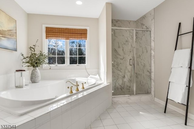 full bathroom featuring tile patterned flooring, a marble finish shower, a bath, and baseboards