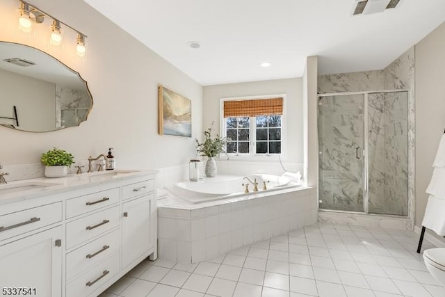 bathroom featuring a garden tub, a sink, a marble finish shower, and double vanity