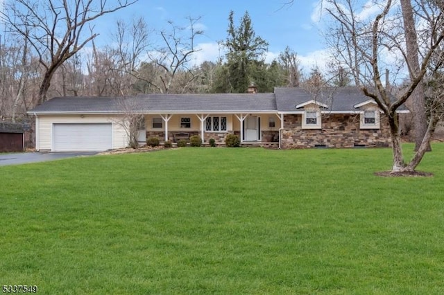 ranch-style house featuring driveway, a garage, stone siding, a porch, and a front yard