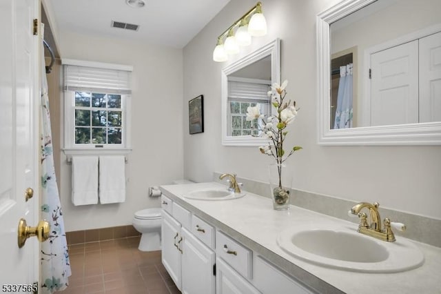 full bath featuring double vanity, tile patterned flooring, a sink, and visible vents