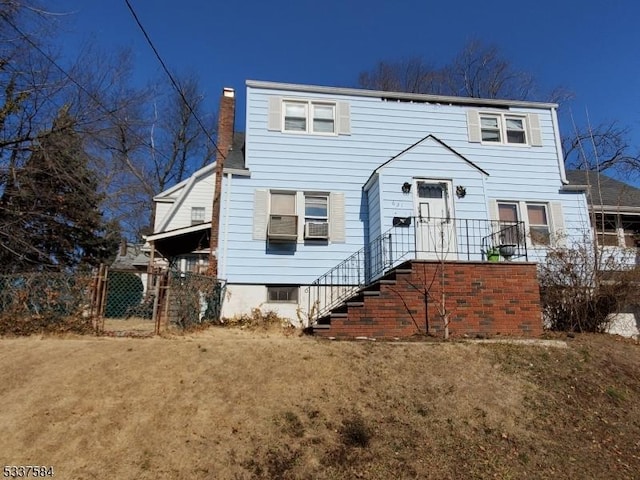 view of front of home featuring a chimney, a front yard, and fence