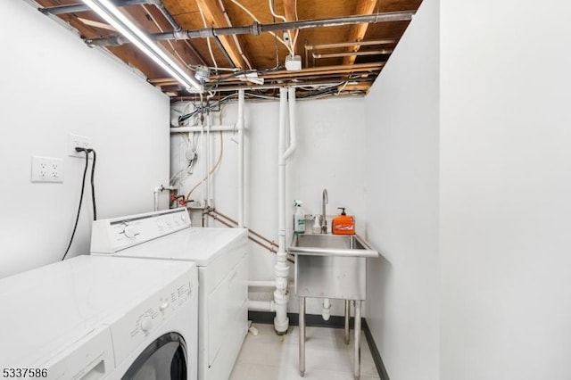 laundry room with washing machine and dryer and sink