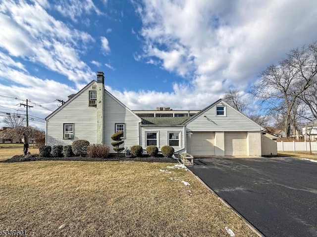 view of front of house with a garage and a front yard