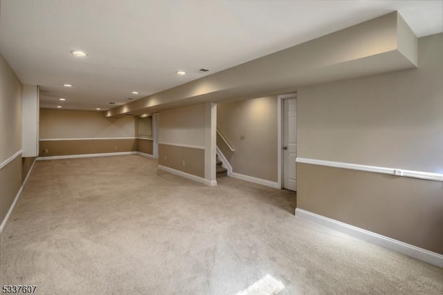 finished below grade area with carpet, recessed lighting, baseboards, and stairs