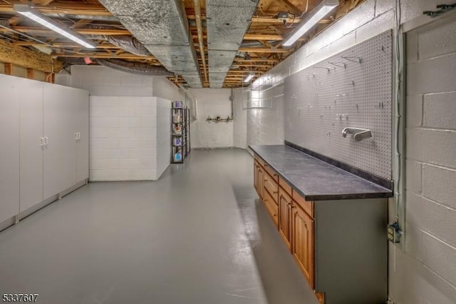 unfinished basement with concrete block wall