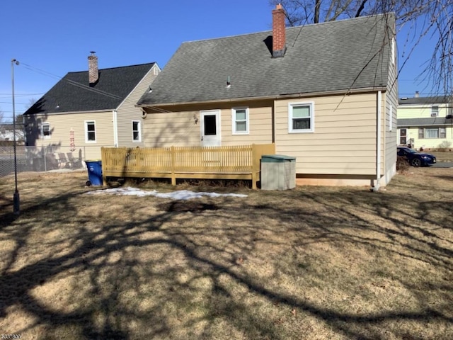 rear view of house featuring a wooden deck