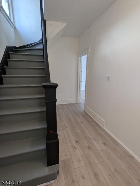 staircase featuring hardwood / wood-style flooring