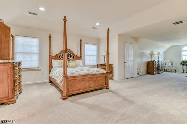 bedroom featuring light colored carpet, visible vents, and baseboards