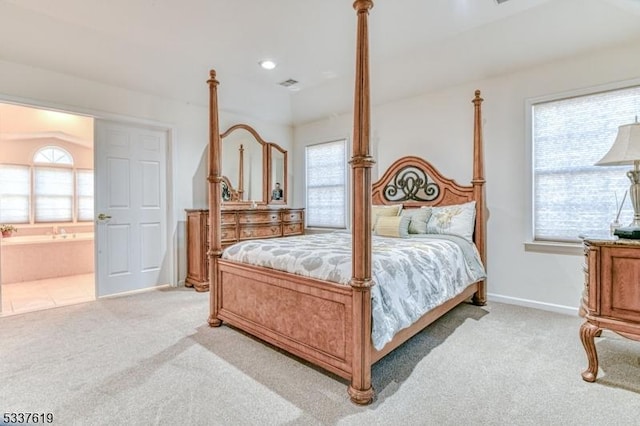 bedroom featuring visible vents, carpet floors, baseboards, and ensuite bathroom