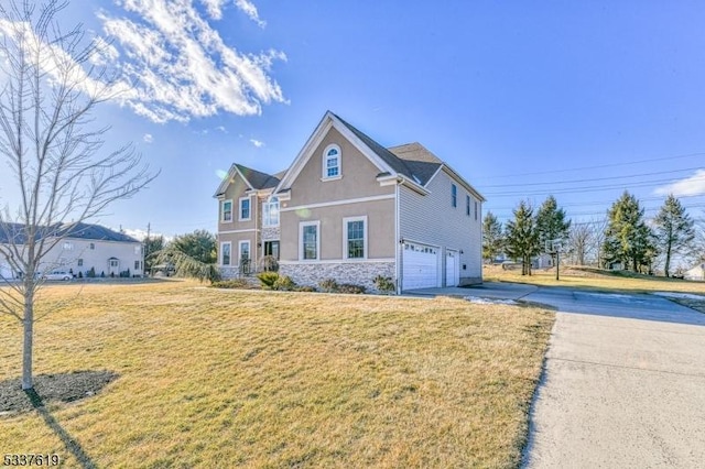 view of front facade featuring a front lawn, concrete driveway, stucco siding, a garage, and stone siding