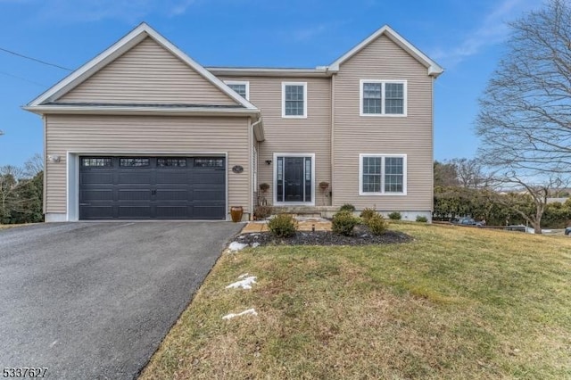 view of front of property with a garage and a front yard