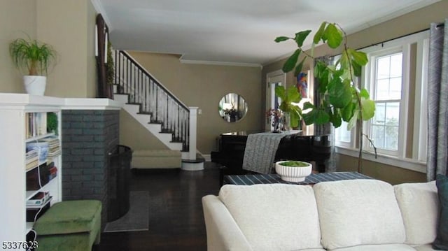 living room with stairway, wood finished floors, and ornamental molding