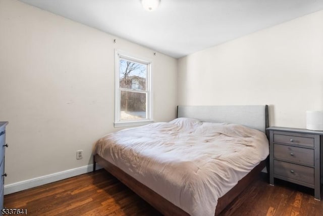 bedroom with dark hardwood / wood-style flooring