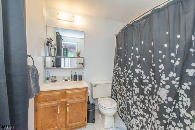 bathroom with vanity, tile patterned flooring, toilet, and walk in shower