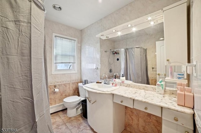 bathroom featuring tile patterned floors, toilet, tile walls, vanity, and curtained shower