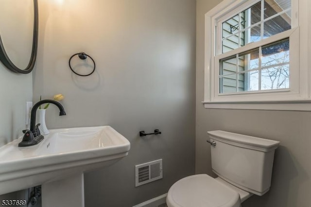 bathroom with visible vents, a sink, and toilet