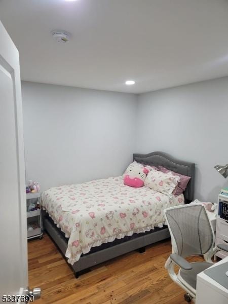 bedroom with wood-type flooring