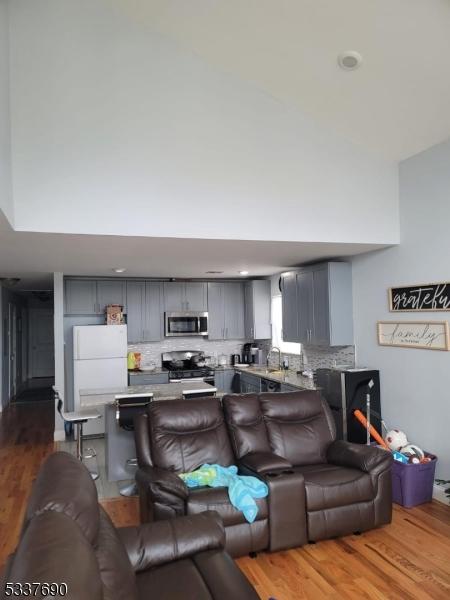 living room with sink and wood-type flooring